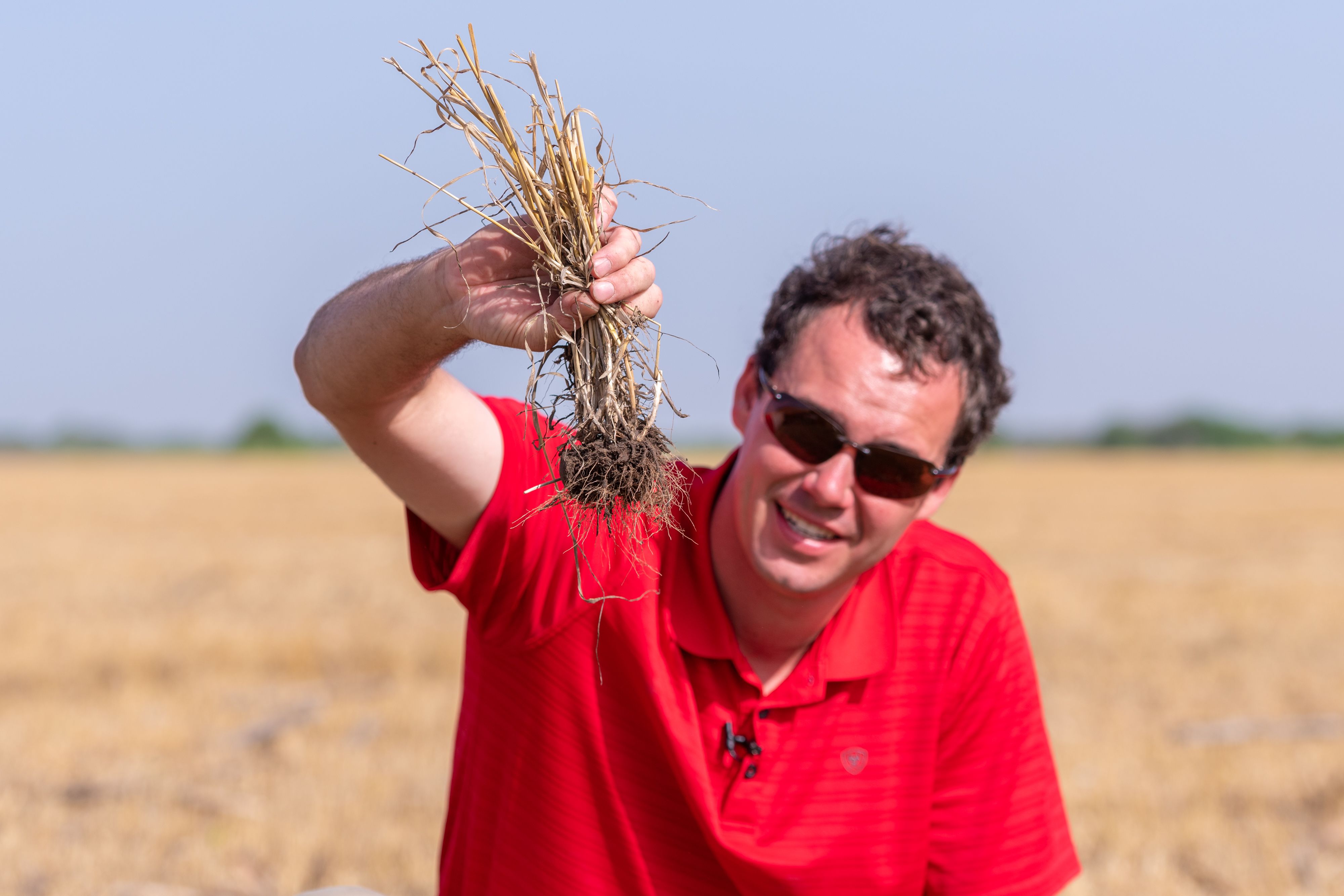 James Moreland with a handful of wheat residue that’s been holding the soil in place, protecting it from erosion. 